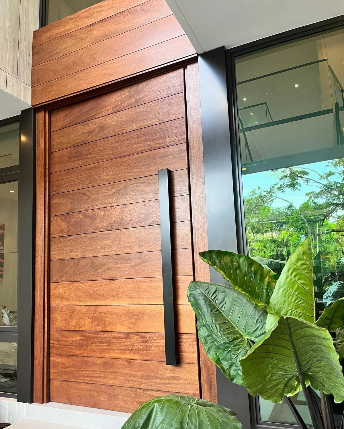Featured custom pivot entry door installation, Miami residence